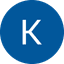 White capital letter K on a solid blue circular background with black edges