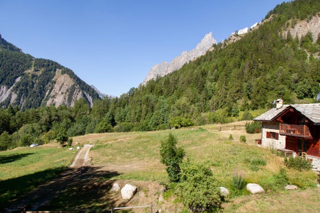 Rifugio Chapy near Mont Blanc with stone and wood chalet in a sunny alpine meadow.