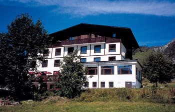 Chalet Alpin du Tour hotel building with balconies in a sunny alpine setting.
