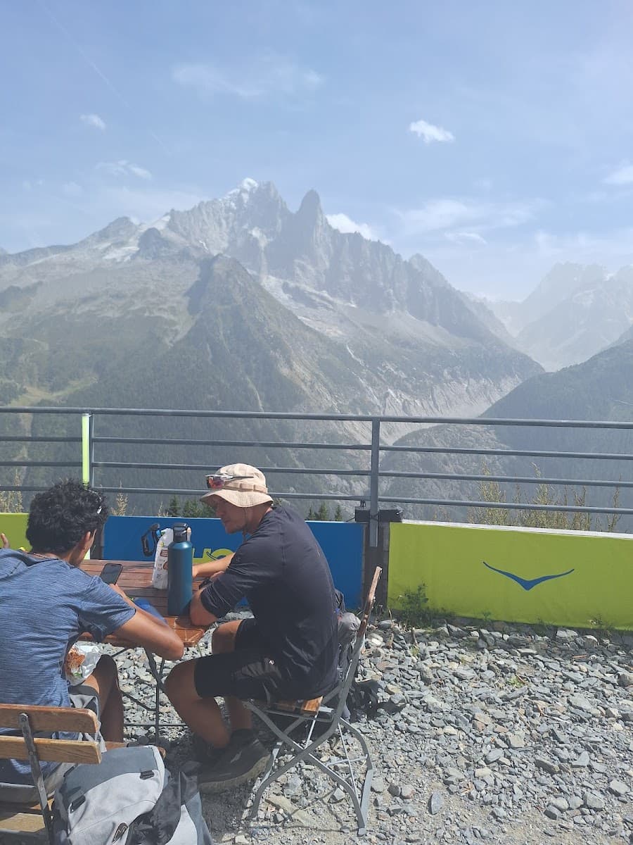Two hikers sitting at an outdoor table with mountain views