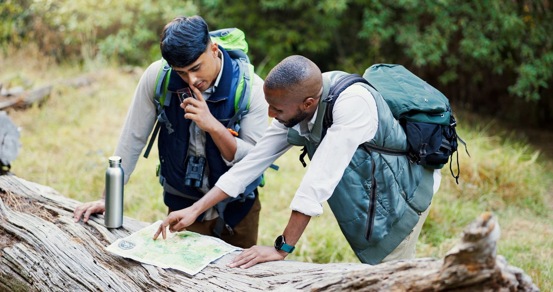 People, talking and maps for hiking outdoor of trekking directions, forest navigation and direction. Lost men, discussion and woods with guide of travel journey, adventure path and destination search